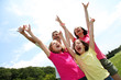 Foto : Cheerful family lifting arms up in the air Cheerful family lifting arms up in the air