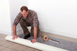 Image : Man unrolling carpet