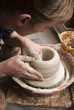 hands of a potter, creating an earthen jar on the circle hands of a potter, creating an earthen jar on the circle