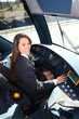 Female tram conductor sat at controls