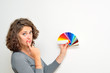 young woman holding a color scale