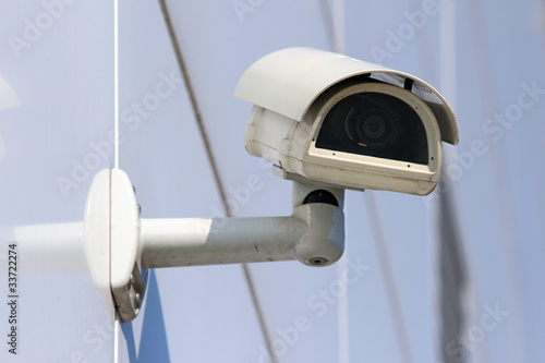 Photo: white security cctv camera on the modern facade white security cctv camera on the modern facade