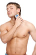 Portrait of a young handsome man shaving