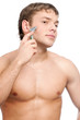 Portrait of a young handsome man shaving