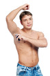 Muscular man's using an antiperspirant