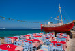 The famous red boat and a tavern on the island of Mykonos