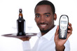 black wine waiter showing a telephone