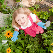 Little gardener in herbal garden