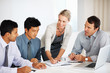 Happy female leader discussing business plan with team