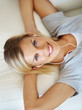Pretty woman listening music on couch