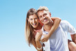 Photo: Happy man piggybacking woman Happy man piggybacking woman