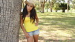 Pretty young tan woman relaxing in the park