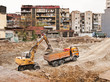 construction machine excavating earth into a truck.