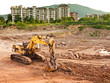bulldozer machine excavating earth near city