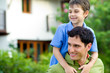 Father giving his son a piggyback ride