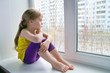Sad child at the window.