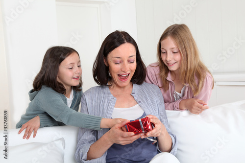 Photo: Girls giving present on mom's birthday Girls giving present on mom's birthday