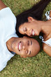 Happy love couple lying together on grass