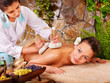 Woman getting thai herbal compress massage . Woman getting thai herbal compress massage .