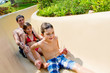 Father and Children Sliding Down Water Slide