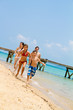 Family running on the beach