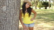 Sexy young brunette woman at the park smiling