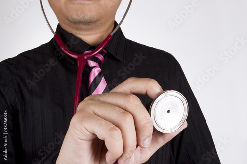 Photo: diagnose, doctor black shirt pink tie use stethoscope diagnose. diagnose, doctor black shirt pink tie use stethoscope diagnose.