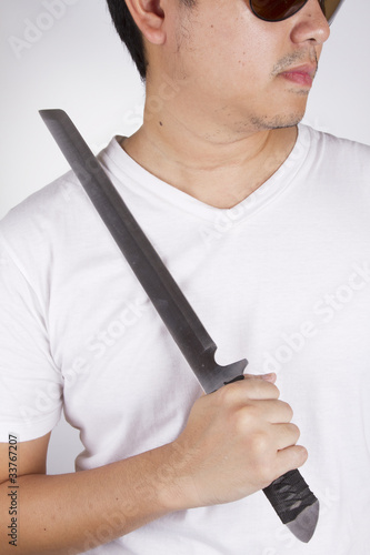 Photo: ninja sword, male model wear sunglasses pose with ninja knife. ninja sword, male model wear sunglasses pose with ninja knife.