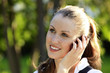 Young smiling woman speaks by mobile phone Young smiling woman speaks by mobile phone