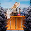 tiroler girl in the snow behind a bar