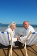 Portrait of senior couple sitting in deckchairs