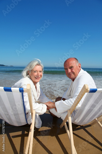 Photo: Portrait of senior couple sitting in deckchairs Portrait of senior couple sitting in deckchairs