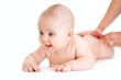 Photo: baby lying isolated getting massage from mother's hands baby lying isolated getting massage from mother's hands