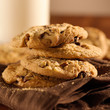 chocolate chip cookies and glass of milk in background