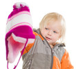 Adorable toddler girl dressing winter jacket and hat. holding ha