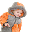 Adorable toddler girl sit in winter jacket with hood on head