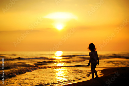 Photo: A child as silhouette by the sea A child as silhouette by the sea