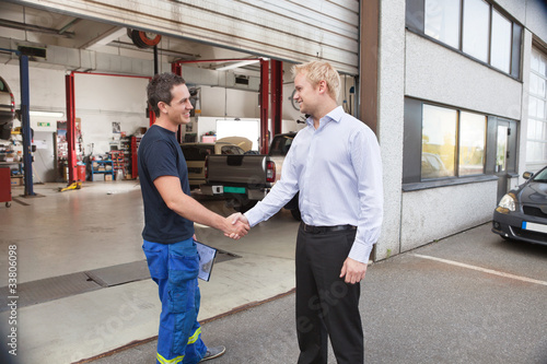 Photo: Mechanic shaking hands with client Mechanic shaking hands with client