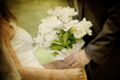 bride and groom's hands holding wedding bouquet