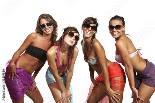 Foto: portrait of four sexy girls in studio, white background portrait of four sexy girls in studio, white background