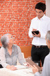 Young waiter taking an order in a restaurant