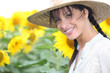 Woman in a straw hat in a sunflower field