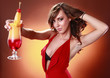 Striking woman in red and Tequila Sunrise cocktail