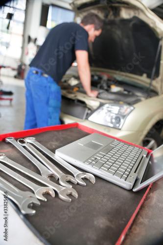 Photo: Closeup of a laptop and wrench Closeup of a laptop and wrench