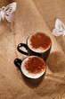hot frothy drink cappuccino chokolate dusted, white paper butter hot frothy drink cappuccino chokolate dusted, white paper butter
