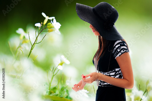 Photo: Beautiful young lady and flowers Beautiful young lady and flowers