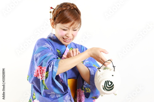 Photo: Young woman wearing Japanese kimono,bitten by mosquito Young woman wearing Japanese kimono,bitten by mosquito