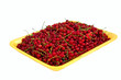 juicy red currant in the yellow plastic tray  is waiting for cus