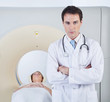 Doctor standing in front of CT scan machine