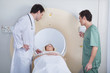 Doctor with technician examining patient